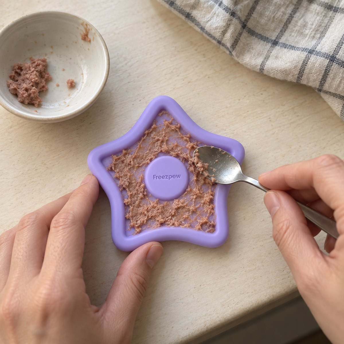 Filling a FreezTwinkle with a soft treat